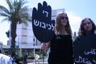 Jen Lauda (l) and Emily Siegel (r) at a rally in Israel. Their signs read "End the Occupation." Photo courtesy of Jen Lauda.